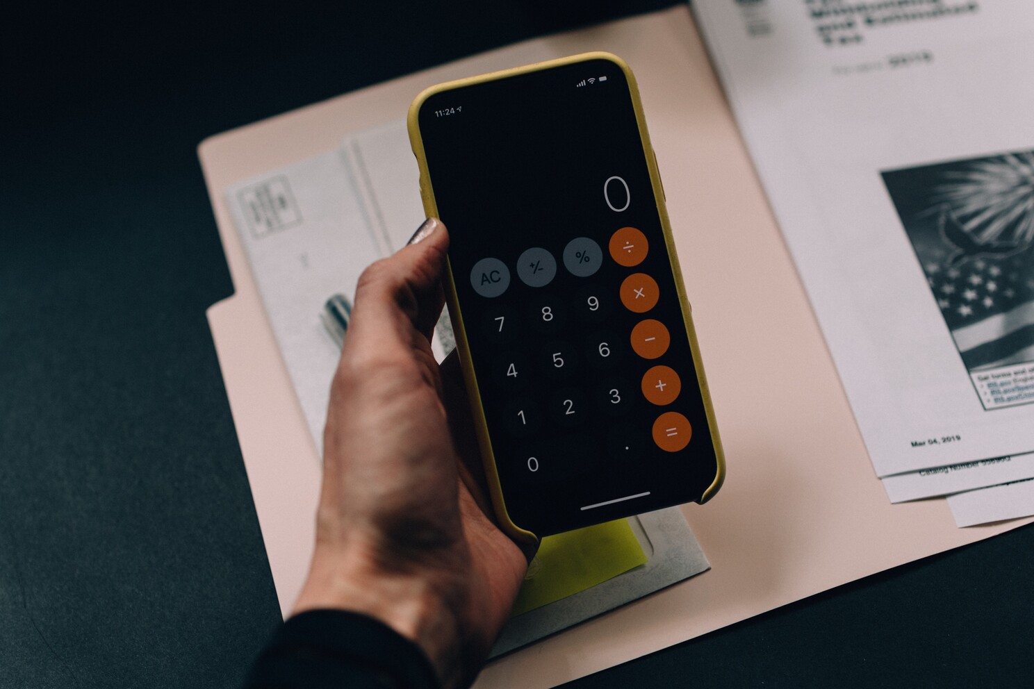 (c) Unsplash. A lady calculating on her phone calculator.