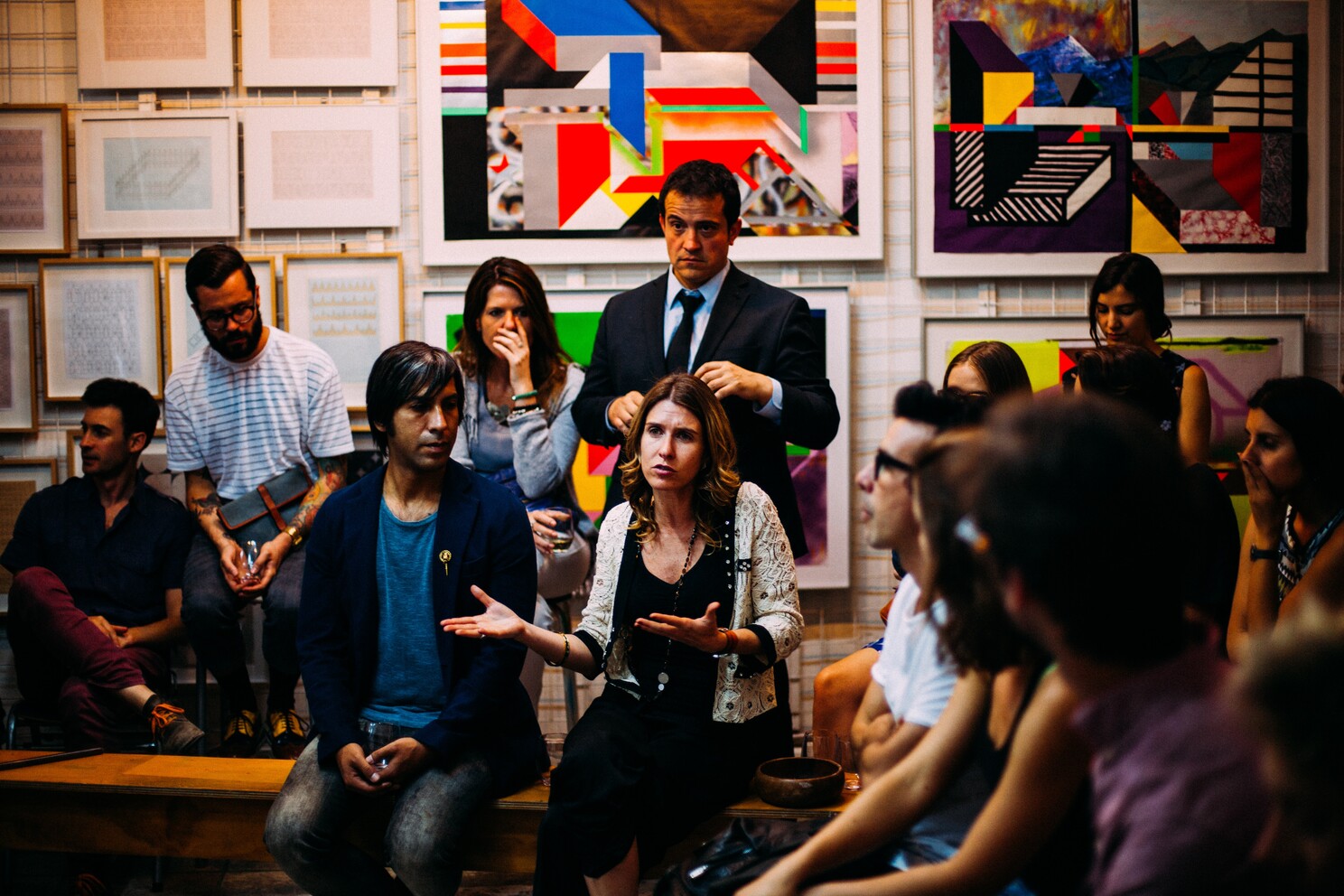 (c) Unsplash. A lady talking in front of a focus group.